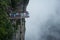 Tourists walk the famous see through glass walkway in Tianmen Mountain