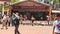 Tourists Walk Feed Pigeon Flock by Cafe near Batu Caves