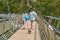 Tourists walk the incredible sky bridge across the abyss on one pillar