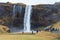 Tourists walk near Seljalandfoss