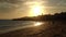 Tourists walk on a Portuguese beach Luz en Lagos, at sunset.