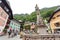 Tourists walk the streets of the town of Hallstatt during a summer day