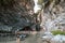 Tourists walking in Alcantara Gorge and Alcantara river park in Sicily Island, Italy.