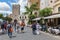 Tourists walking along restaurants at the plaza of Taormina, Italy