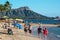 Tourists walking along the shoreline at Waikiki and Diamond Head is a popular and romantic tourist resort in Oahu, Hawaii.