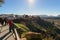 Tourists are walking along traveler path on cliffs around the old town