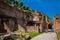 Tourists walking by the archway at Via Nova on the ancient Roman Forum in Rome