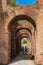 Tourists walking by the archway at Via Nova on the ancient Roman Forum in Rome