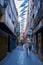 Tourists walking in a Badajoz beautiful street with buildings with beautiful colorful square flags, in Spain