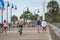 Tourists walking and biking Myrtle Beach Boardwalk telephoto