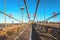 Tourists walking on Brooklyn Bridge in a beautiful day, New York