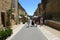 Tourists walking down the main street in the Bastide town of Domme in the Dordogne region of France