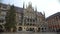 Tourists walking and enjoying amazing architecture on St. Mary Square in Munich