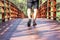 Tourists are walking in the forest on the wooden sidewalk at Stupa in the middle of river in Rayong.