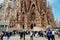 Tourists walking in front of Sagrada Familia