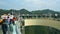 Tourists walking on a glass bridge in the air.