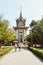 Tourists walking from the memorial tower in the Cambodia Killing Fields Choeung Ek Genocidal Center Phnom Penh