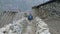 Tourists walking in nepalese village Prok, trek around mountain Manaslu, Nepal.