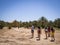 Tourists walking in the Oasis of Merzouga village in Sahara desert, Morocco