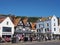 Tourists walking past cafes and the newcastle packet pub on sandside in scarborough in summer sunshine