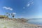 Tourists are walking on the shore on the stone embankment of the Sea of Galilee in Israel