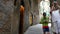 Tourists walking and taking photographs in a street in the historic center of Siena