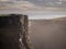 Tourists walking on top of cliff of Moher, Ireland, Rock structure is visible. Concept travel in Europe, Irish landmark