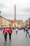 Tourists walking on the tour of the monument near the fountain with a marble sculpture on the Piazza Navona in Rome, capital of I