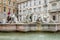 Tourists walking on the tour of the monument near the fountain Moro with marble sculptures in the Piazza Navona in Rome, capital o