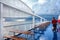 Tourists are walking on the upper deck of cruise ship after the heavy rain storm on the sea