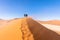 Tourists walking in the wind on Big Daddy near deadvlei.