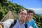 Tourists are walking on a wooden suspension bridge in the park of Yalong Bay Tropic Paradise Forest