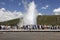 Tourists watch old faithful erupt