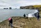 Tourists watching Dyrholaey Arch in south Iceland 