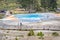 Tourists watching Mound Spring next to Liberty Cap in Mammoth Hot Springs area, Yellowstone Park.