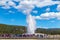 Tourists watching the Old Faithful erupting in Yellowstone National Park