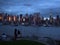 Tourists watching the silhouette of Lower Manhattan at night sky background