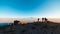 Tourists watching sunrise at Uyuni Salt Flat, travel destination in Bolivia. Wide angle shot from the summit of the Incahuasi Isla