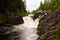 Tourists from waterfall Kivach in Karelia in Russia