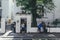 Tourists writing graffiti on the wall of the Abbey Road Shop next to the namesake music studios in London