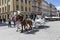 Touristsa enjoy a carriage ride at the Market Square in Krakow