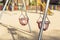 Tow empty swings basket-shape in a playground due to covid-19 quarantine.coronavirus prevention