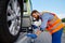 Tow truck operator fixing the car on platform