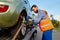 Tow truck operator fixing car on platform