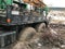 A tow truck stuck in the mud.