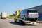 Tow truck transporter carrying car on Road in Slovenia