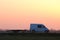 Tow truck vehicle with car carrier trailer driving on highway in evening