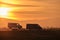 Tow truck vehicle with car transporting carrier trailer driving on highway in evening