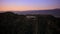 Towards The Hollywood Sign in Los Angeles, aerial sunset above the Hollywood Hills approaching Burbank, California