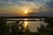 A towboat with barges in the Mississippi river at sunset near the city of Vicksburg in the State of Mississipp